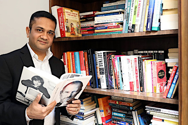 Anupam Gupta at home with his extensive book collection.