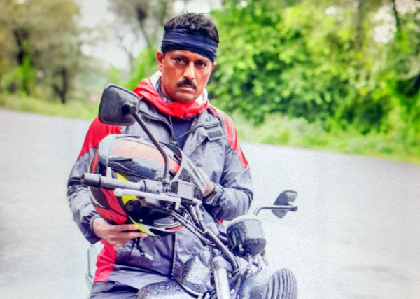 Mahendra Rathod riding to Zanzari Falls on a motorcycle.