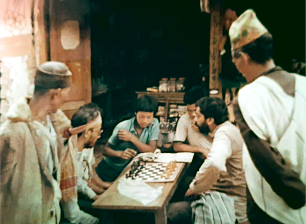 Roger playing chess with the locals.