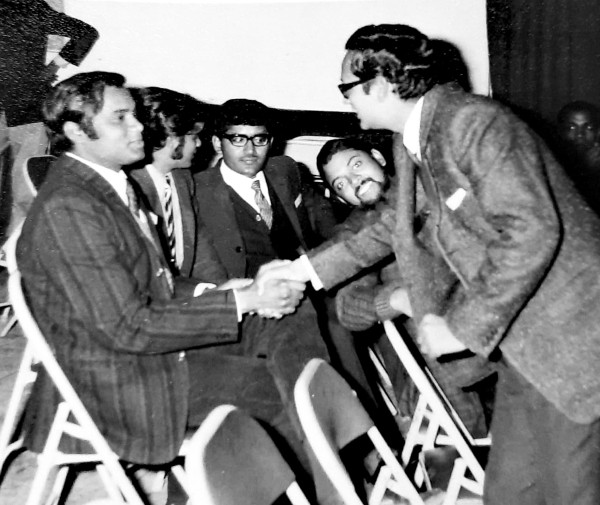 Subhash Mathur shaking hands with Sunil Choudhury. Seated in the middle (from L to R): A Railway Service probationer, Ashish K. Raha and Subhash K. Pali.